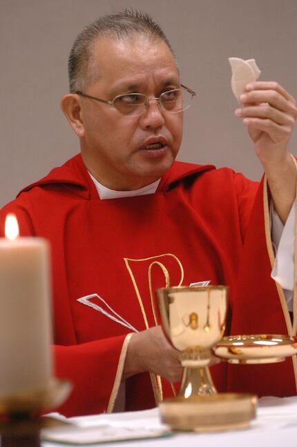 Edmundo Paredes preparing for communion at St. Cecilia Catholic Church in 2008.