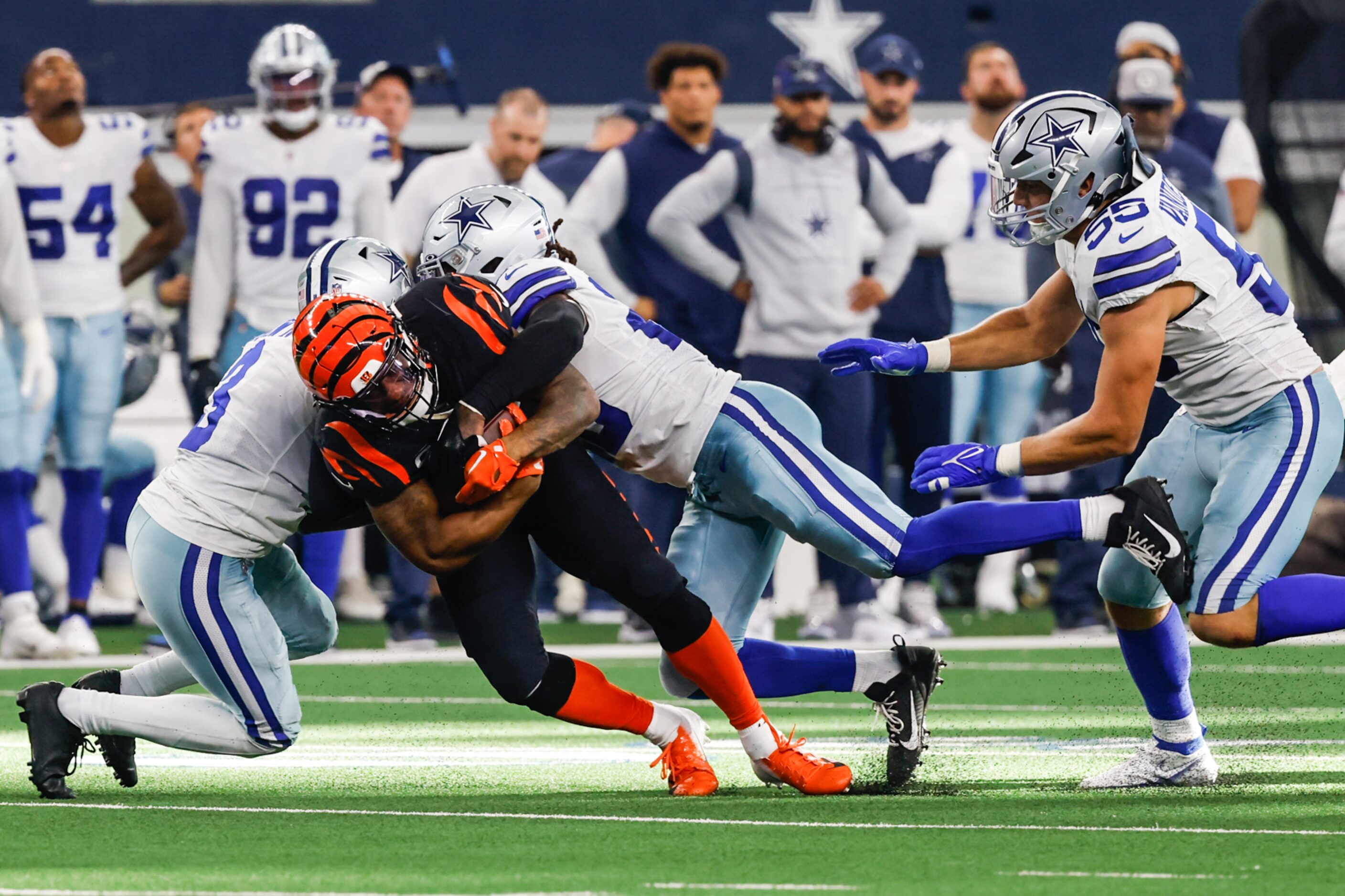 Cincinnati Bengals running back Joe Mixon (28) gets tackled by Dallas Cowboys safety Malik...