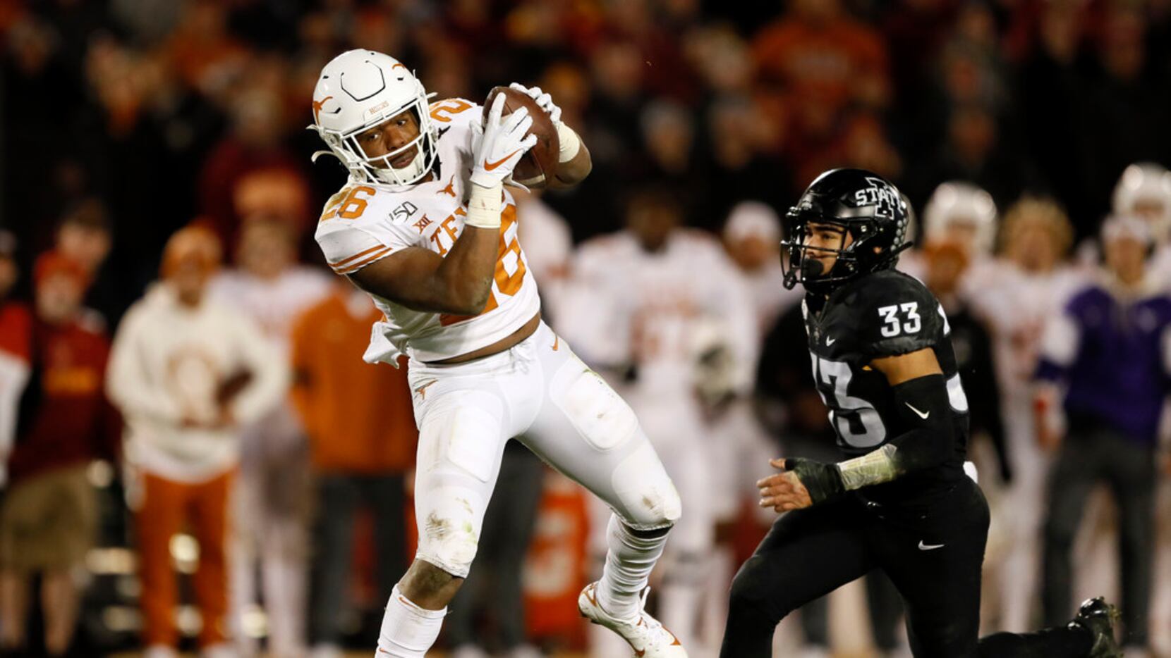 Texas running back Keaontay Ingram catches a 22-yard touchdown pass in front of Iowa State...
