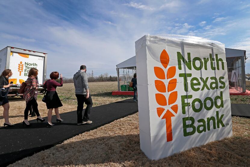 Guests walk to attend a groundbreaking ceremony at the site of North Texas Food Bank's...