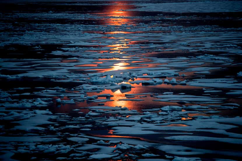 The midnight sun shines across sea ice along the Northwest Passage in the Canadian Arctic...