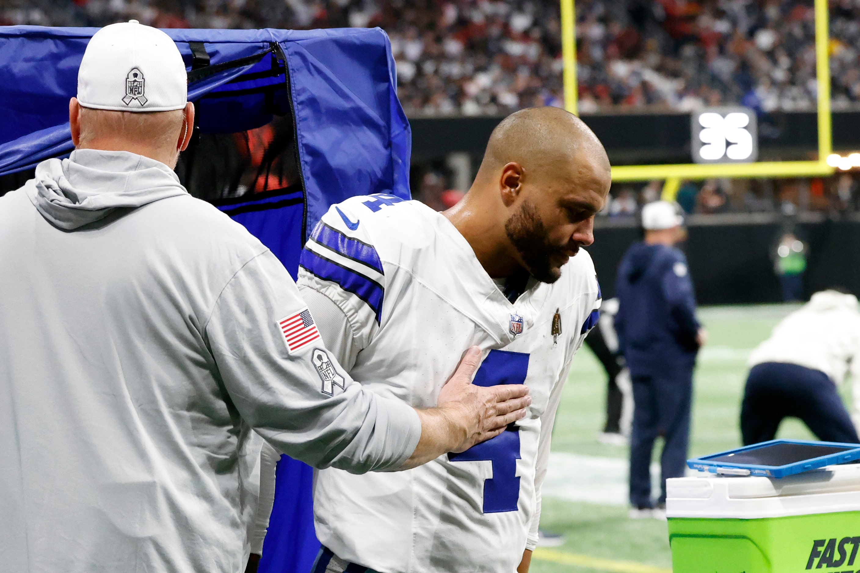 Dallas Cowboys quarterback Dak Prescott (4) exits the medical tent after getting treatment...