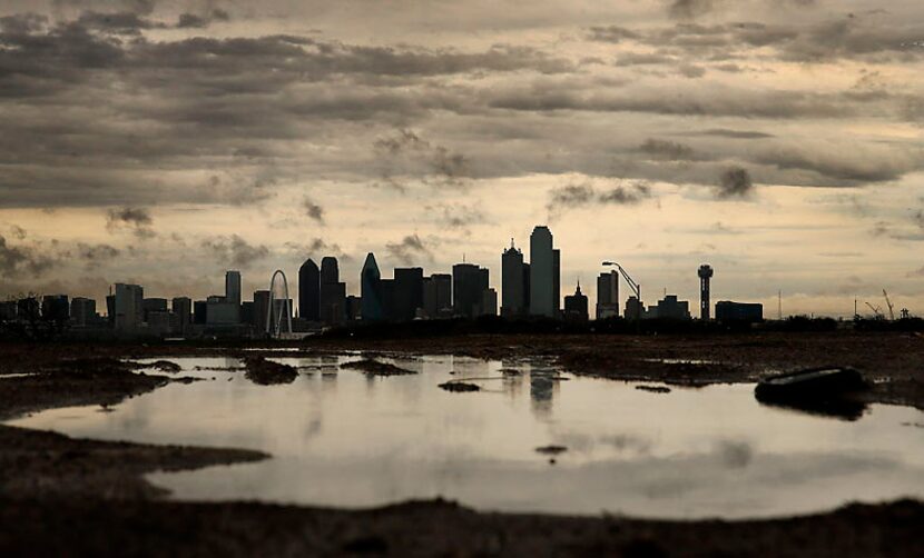  Clouds break up over downtown Dallas after a round of thunderstorms in early March. (Tom...