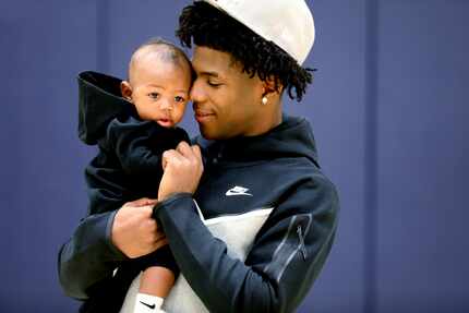 Kendric Davis poses with his 4-month-old son Kendric Jr, at SMU's Moody Coliseum in Dallas,...