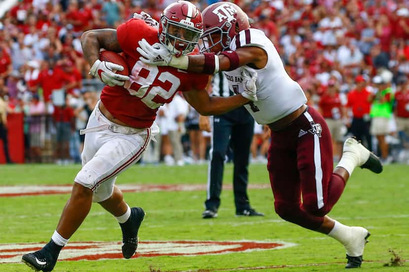 Alabama tight end Irv Smith Jr. (82) breaks free from the arms of Texas A&M defensive back...