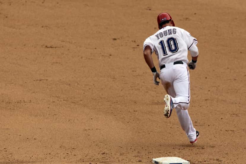 Texas infielder Michael Young circles the bases after hitting a homer during the Texas...