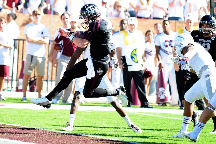 STARKVILLE, MS - NOVEMBER 03:  Johnny Manziel #2 of the Texas A&M Aggies leaps into the...