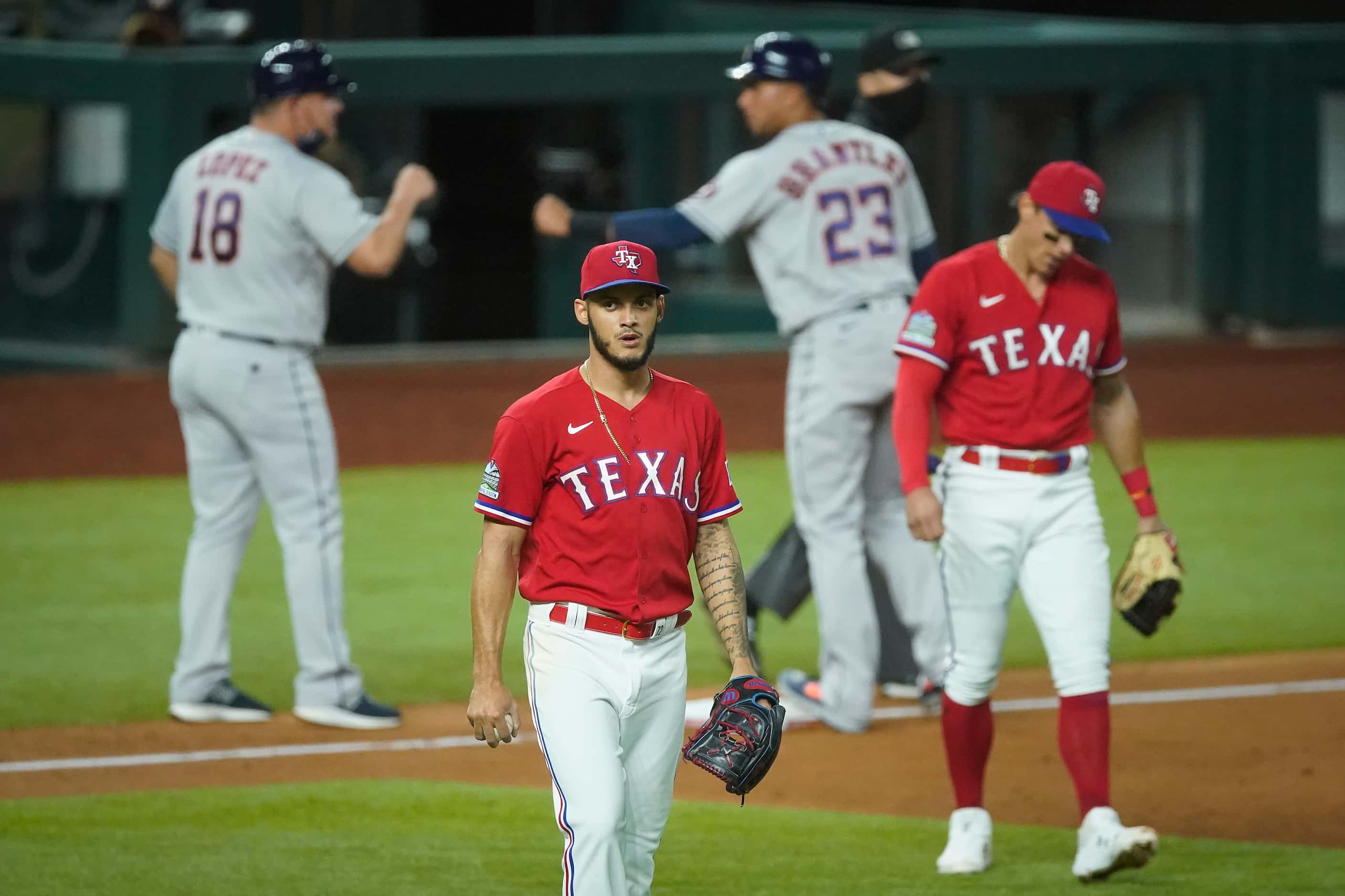 Texas Rangers pitcher Jonathan Hernandez and third baseman Derek Dietrich react after a...
