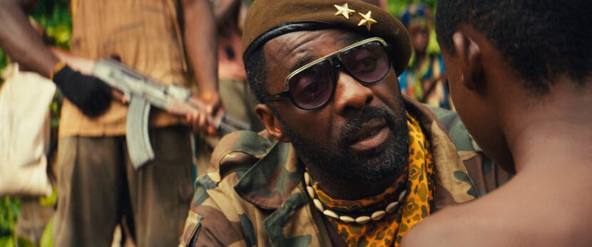 Idris Elba, center, as Commandant, in the Netflix original film, "Beasts of No Nation,"...