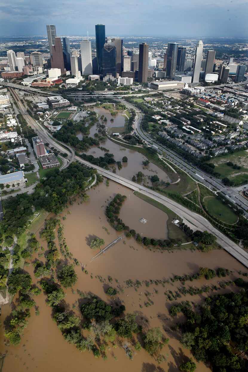 The swollen Buffalo Bayou is pictured in front of the Houston, Texas skyline, Wednesday,...