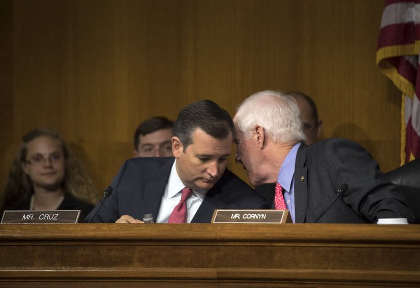 Texas Sens. Ted Cruz and John Cornyn confer during a subcommittee meeting in 2016.