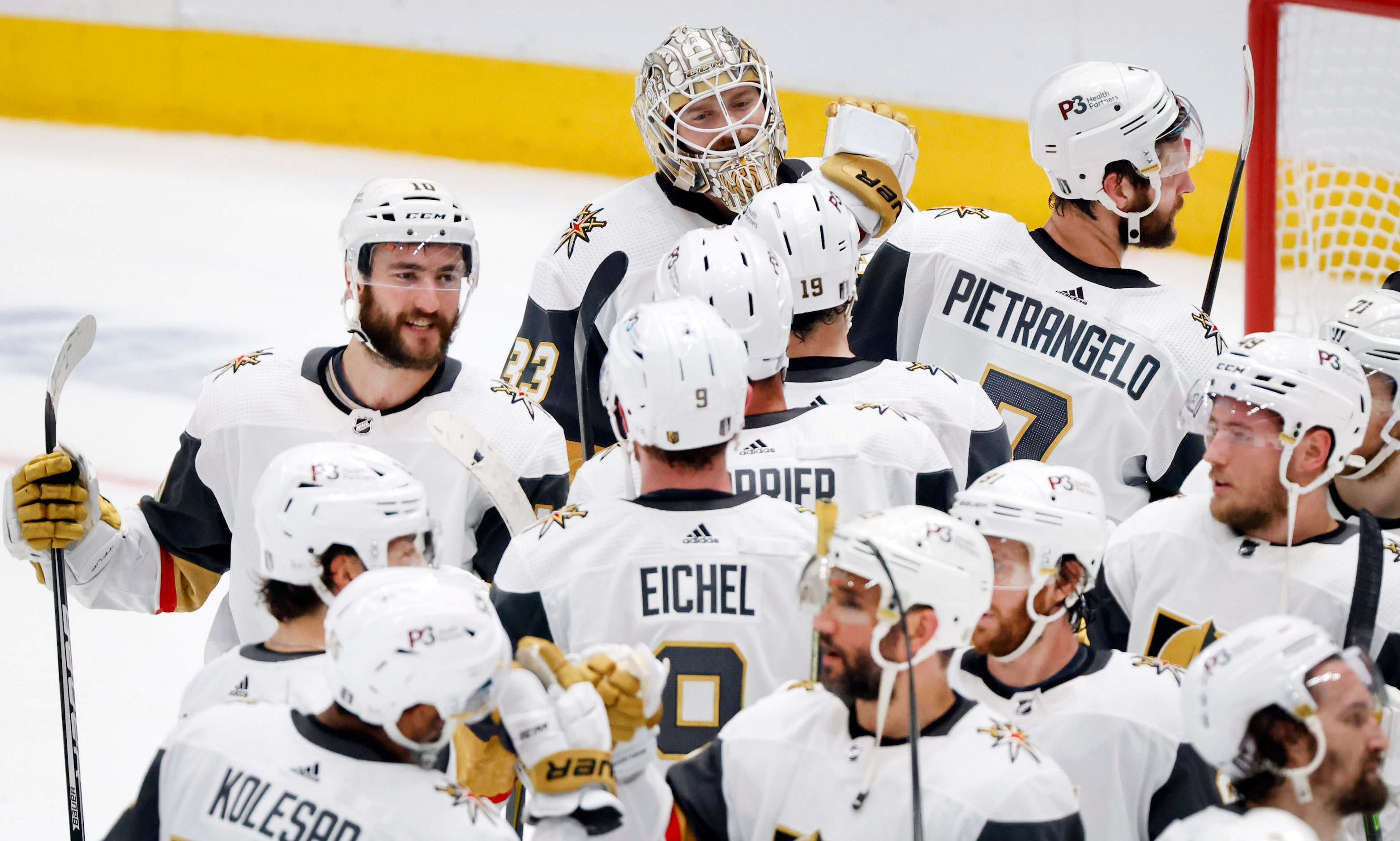 Vegas Golden Knights players congratulate goaltender Adin Hill (back left) on his shutout...