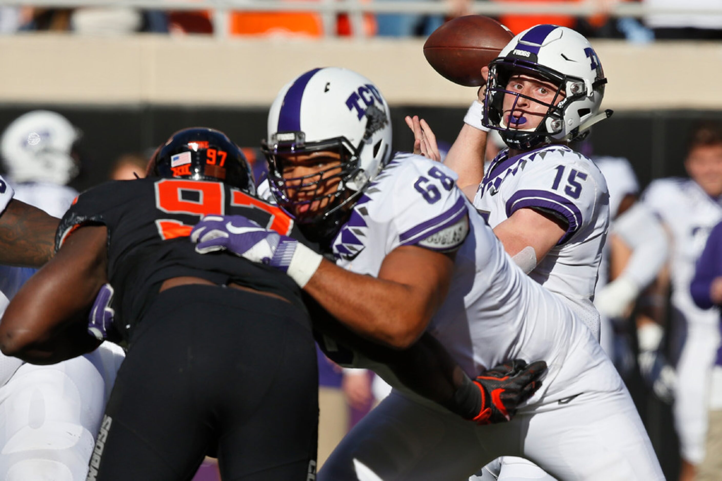 TCU quarterback Max Duggan (15) passes as offensive tackle Anthony McKinney (68) blocks...