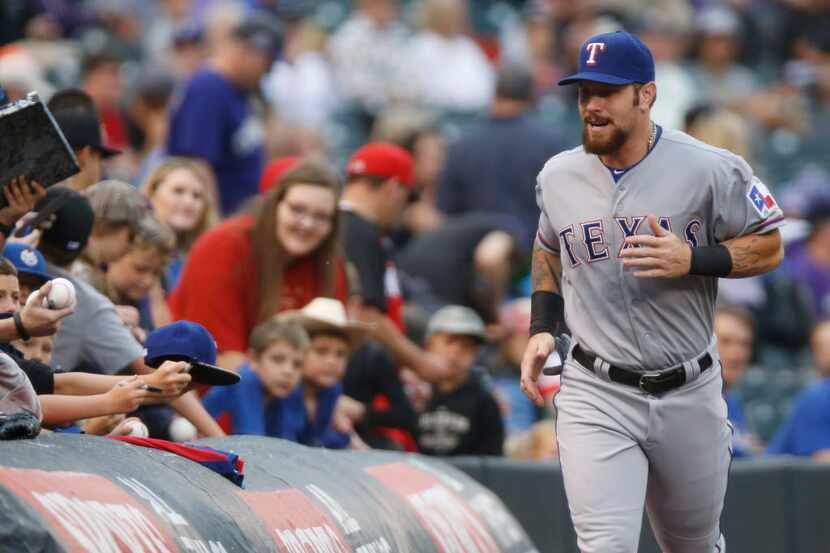 Texas Rangers right fielder Josh Hamilton heads to dugout to face the Colorado Rockies in a...