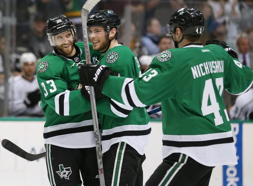 Dallas Stars defenseman Alex Goligoski (33) celebrates with center Tyler Seguin (91) and...