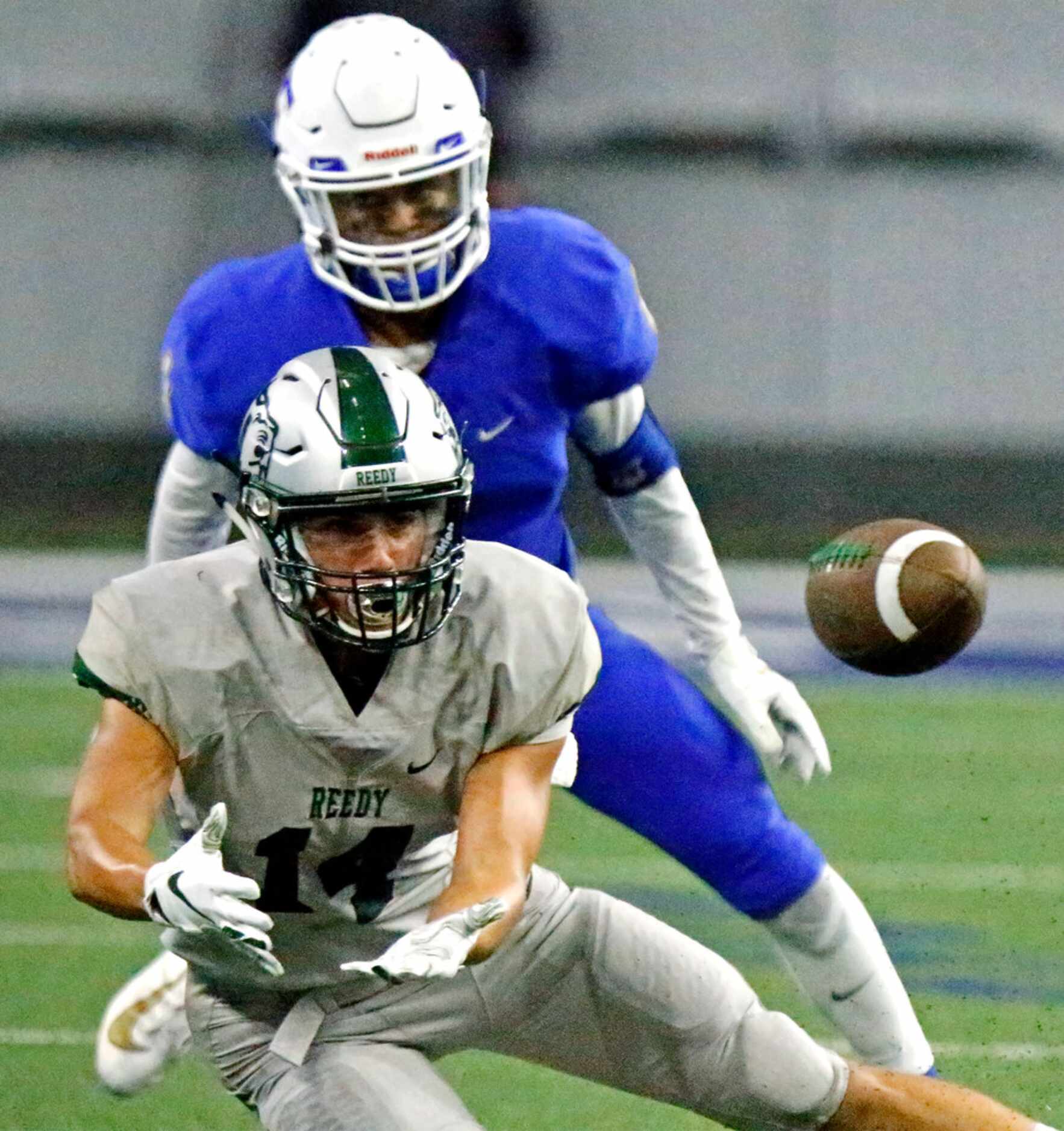 Frisco High School wide receiver Graham Hawks (14) attempts to catch a pass in front of...