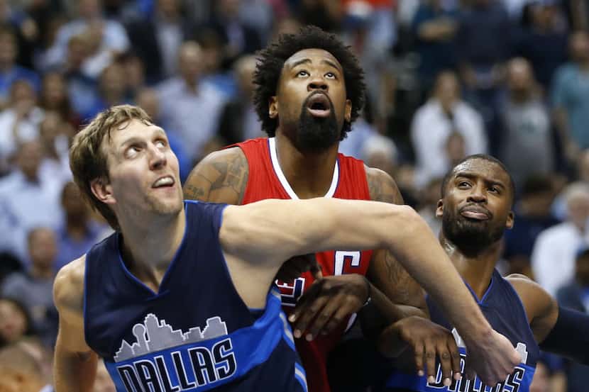 The Clippers' DeAndre Jordan, shown here against Dirk Nowitzki and Wesley Matthews, was...