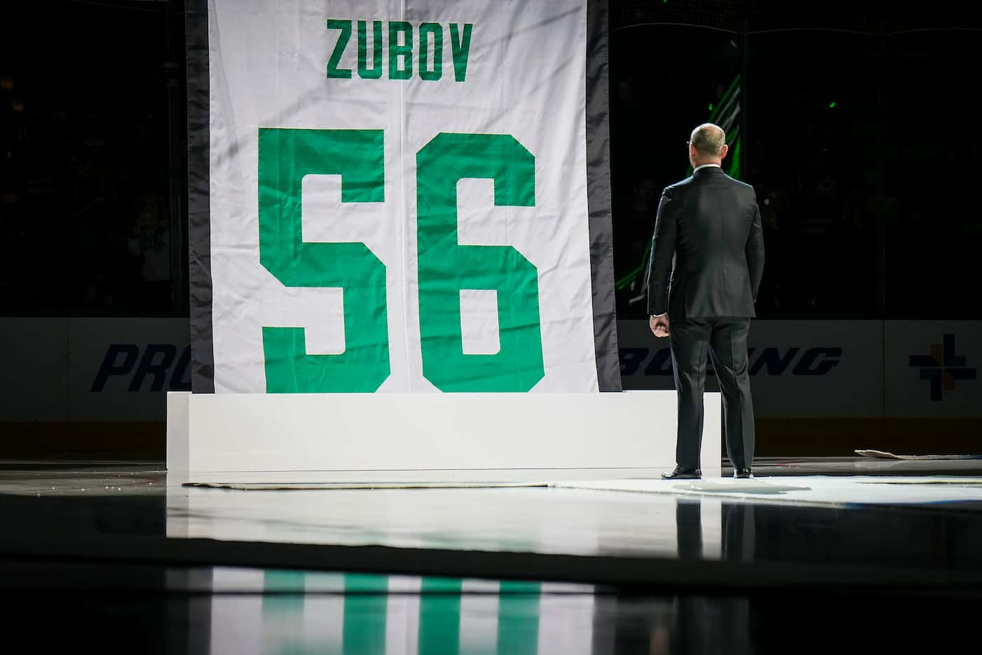 Former Dallas Stars player Sergei Zubov watches as a banner bearing his number 56 is raised...