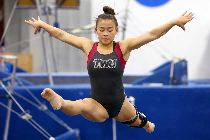 Gymnast Kyla Podges warms up during a practice at Texas Woman’s University on Tuesday, March...