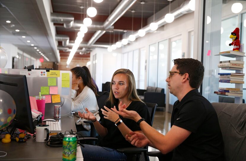 Kristy Lewelling and Jack Sperco confer at Simpli.fi in Fort Worth in August.