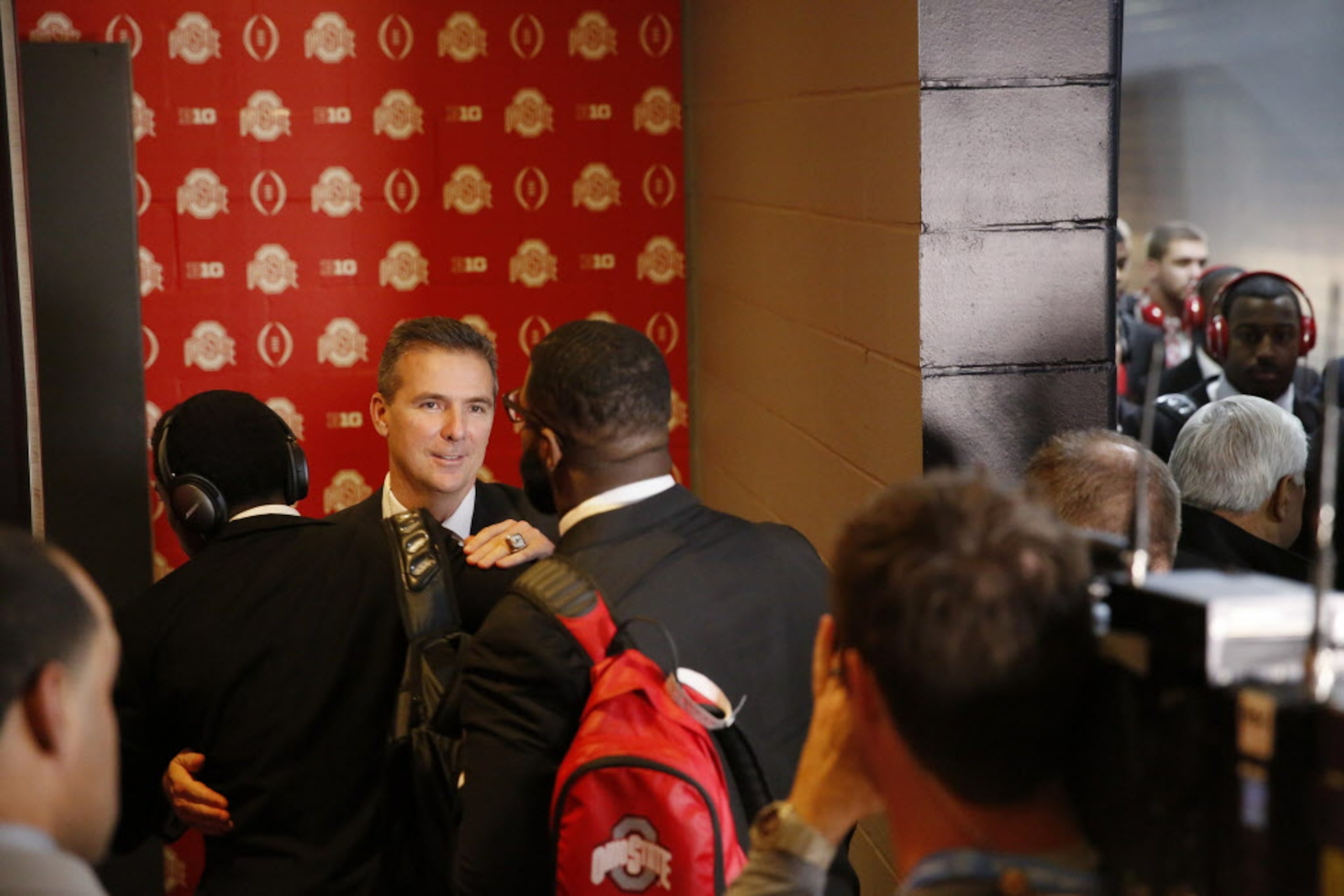 Ohio State Buckeyes head coach Urban Meyer welcomes his players to the locker room before...