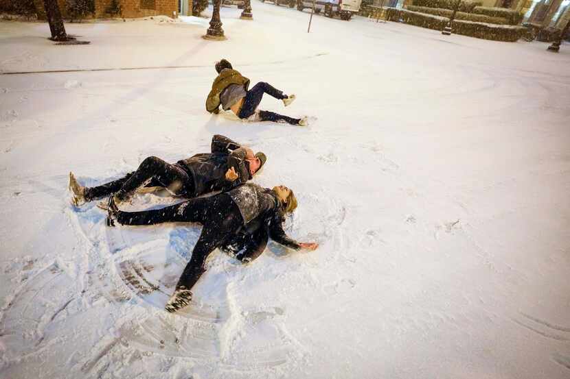 Gabriel Wilke and Gabrielle Rader do snow angles in the middle of Thomas Avenue near Griggs...