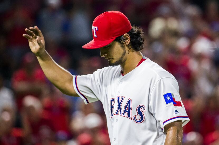 Texas Rangers starting pitcher Yu Darvish (11) waves to fans as he walks to the dugout after...
