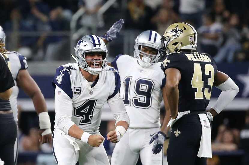 Dallas Cowboys quarterback Dak Prescott (4) celebrates after running the ball against the...