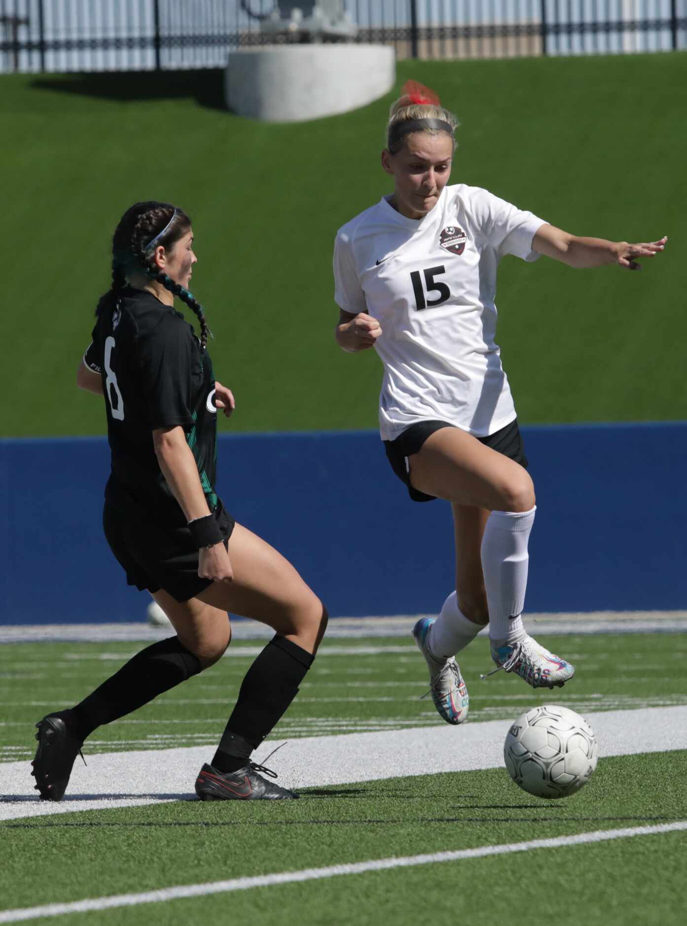 Southlake Carroll player #8, Hanna Khan, tries to stop Flower Mound Marcus player #15,...