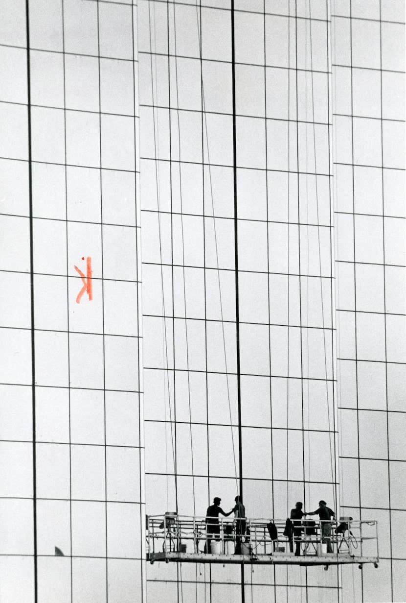 Workers clean glass on the Hyatt Regency in 1978.