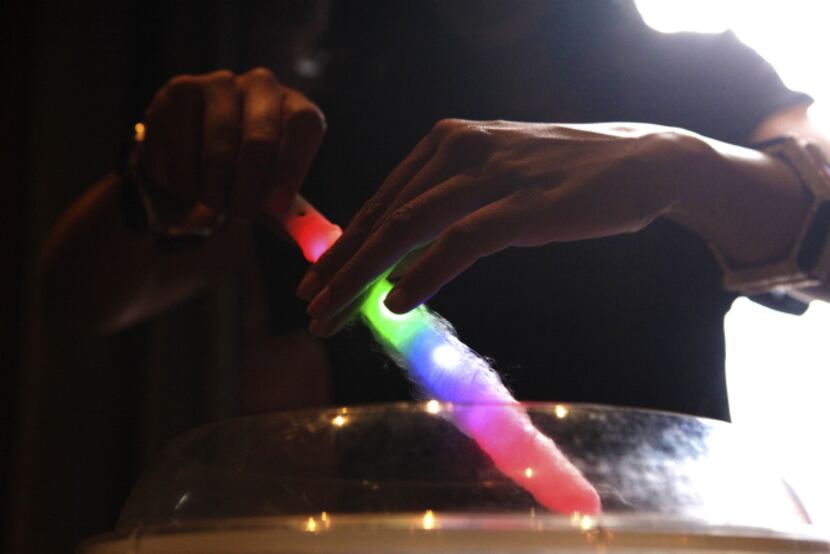 Yasmeen Tadia makes a pop spun around a light stick that blinks.