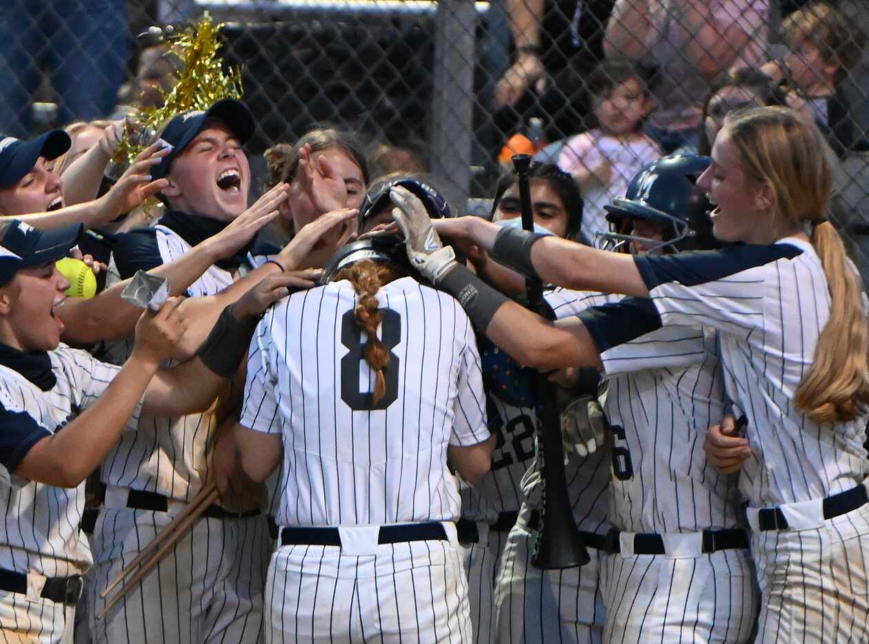 Flower Mound’s Carsyn Lee celebrates with teammates after her two-run home run during game 1...