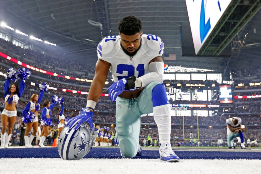 Dallas Cowboys running back Ezekiel Elliott prayed before the kickoff between the Cowboys...
