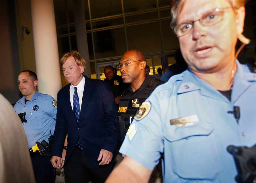 Former Klansman and current U.S. Senate candidate David Duke is hastily escorted to a police...