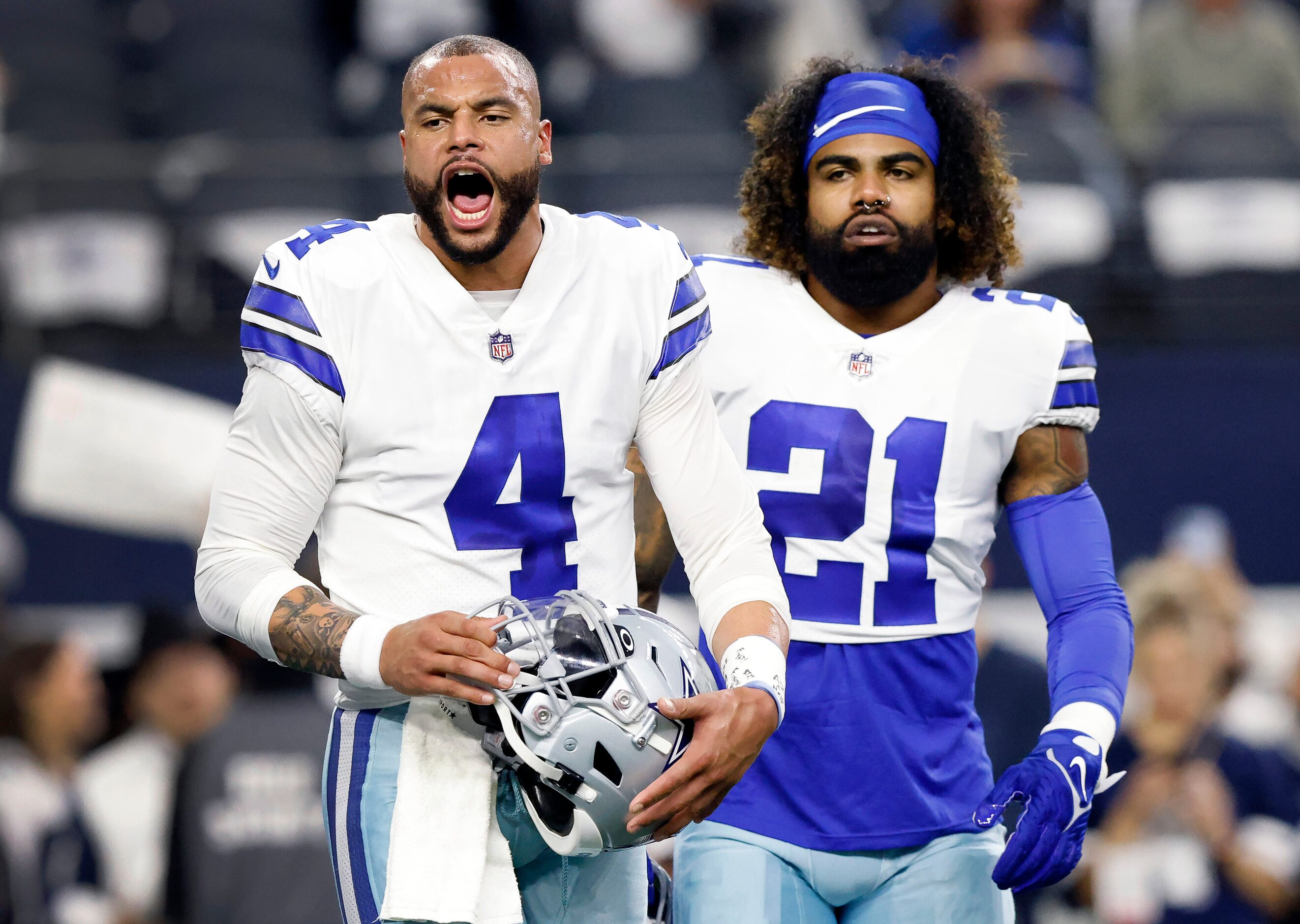 Dallas Cowboys quarterback Dak Prescott (4) gets his team fired up during pregame warmups as...