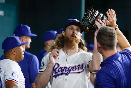 Texas Rangers pitcher Jon Gray is greeted by his teammates after exiting the play during the...