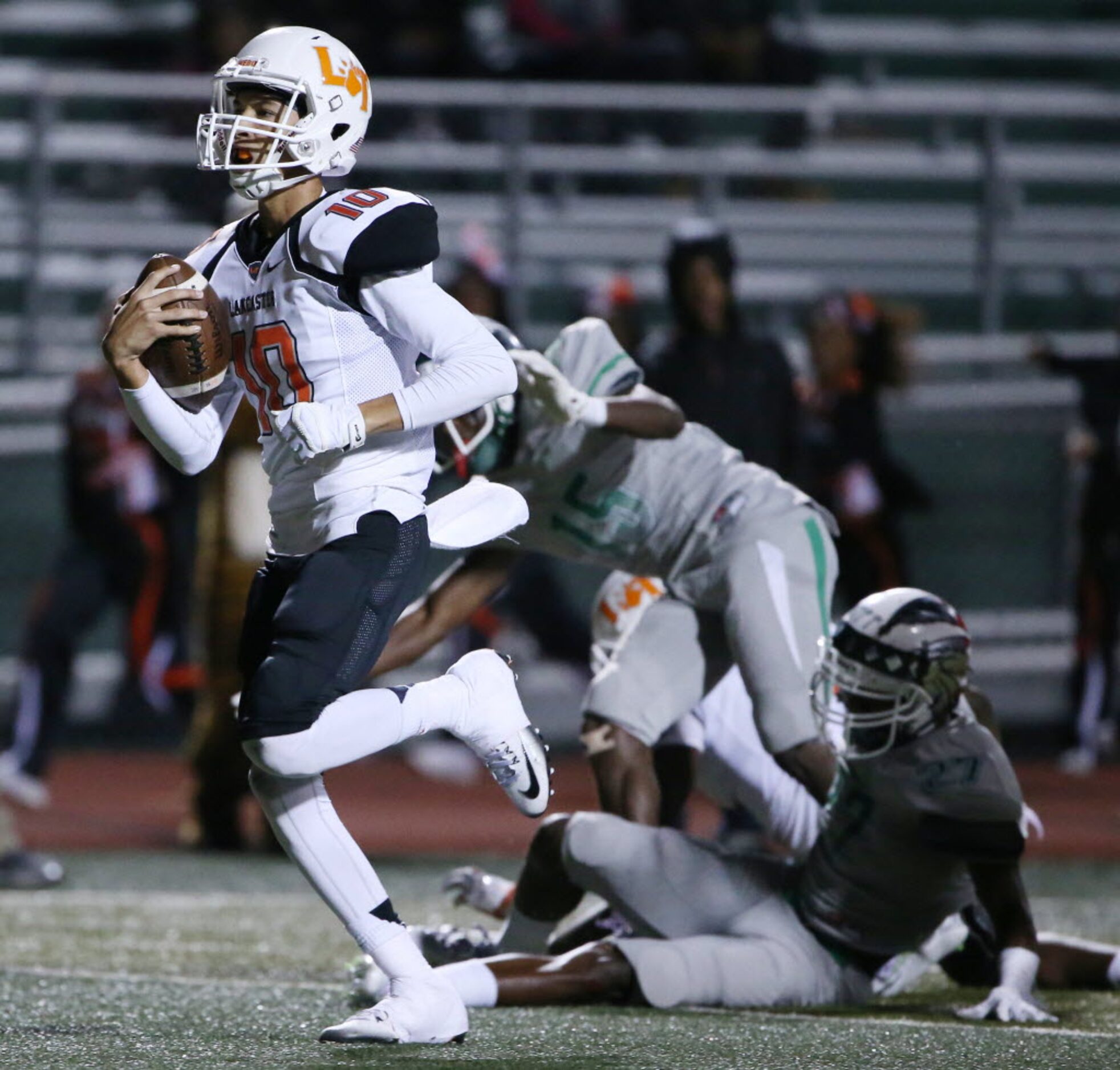 Lancaster quarterback Ryan Ross (10) scores a touchdown while rushing the ball to make the...