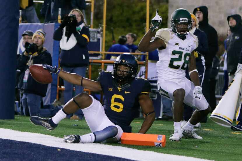 West Virginia wide receiver Daikiel Shorts (6) looks to see if he caught the ball in bounds...