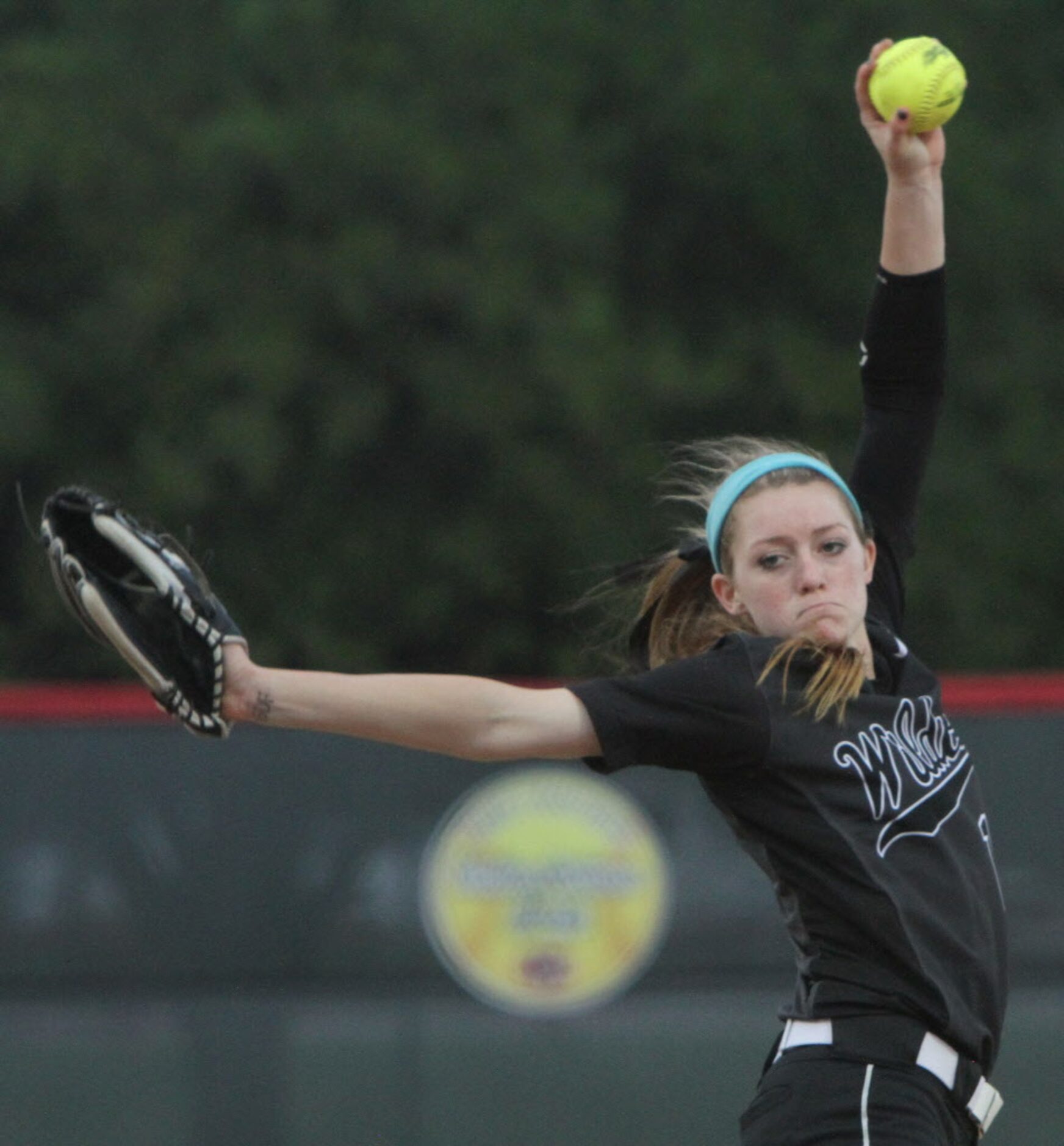 Denton Guyer pitcher Shayne Starkey (13) goes through her windup before delivering a pitch...