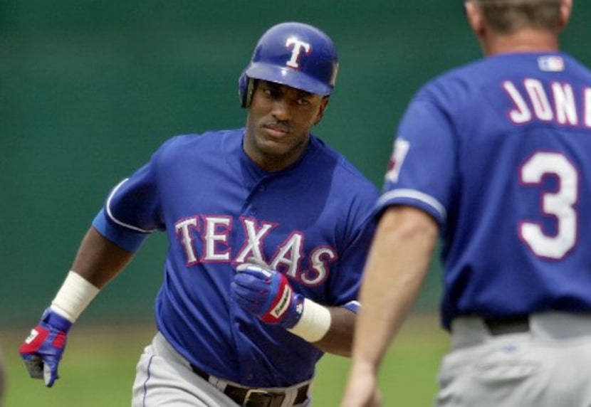 ORG XMIT: S0361409169_WIRE Texas Rangers' Ruben Sierra, left, passes third base coach Bobby...