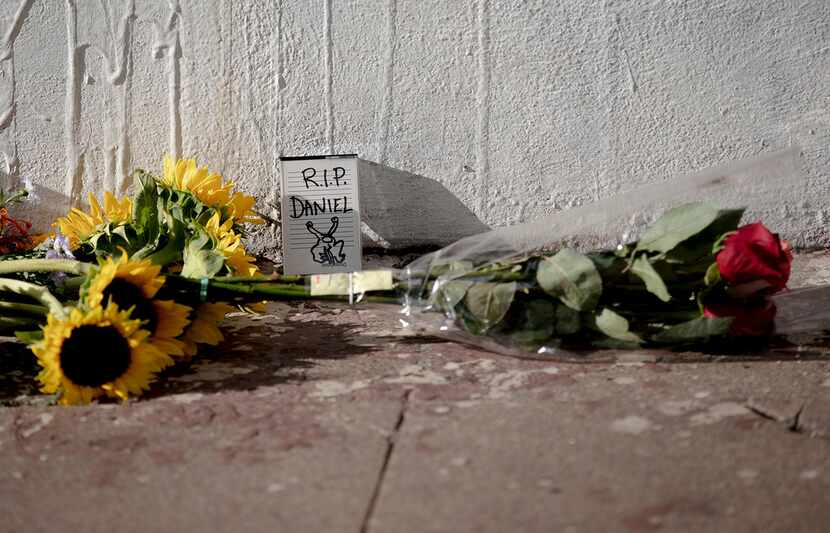 Flowers and a note are seen at the "Hi, How Are You" mural created by Daniel Johnston on...