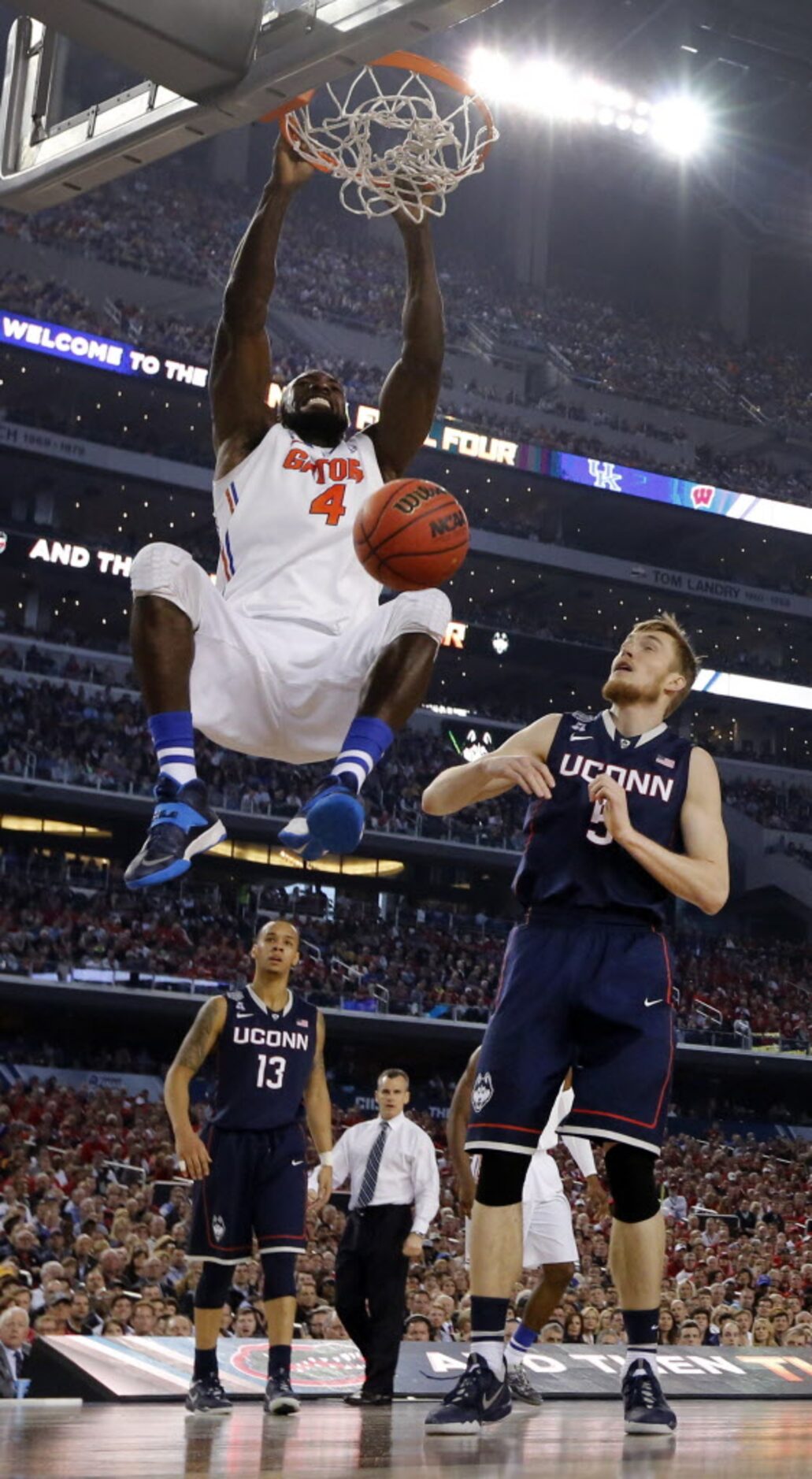 Florida Gators center Patric Young (4) dunks the ball against Connecticut Huskies...