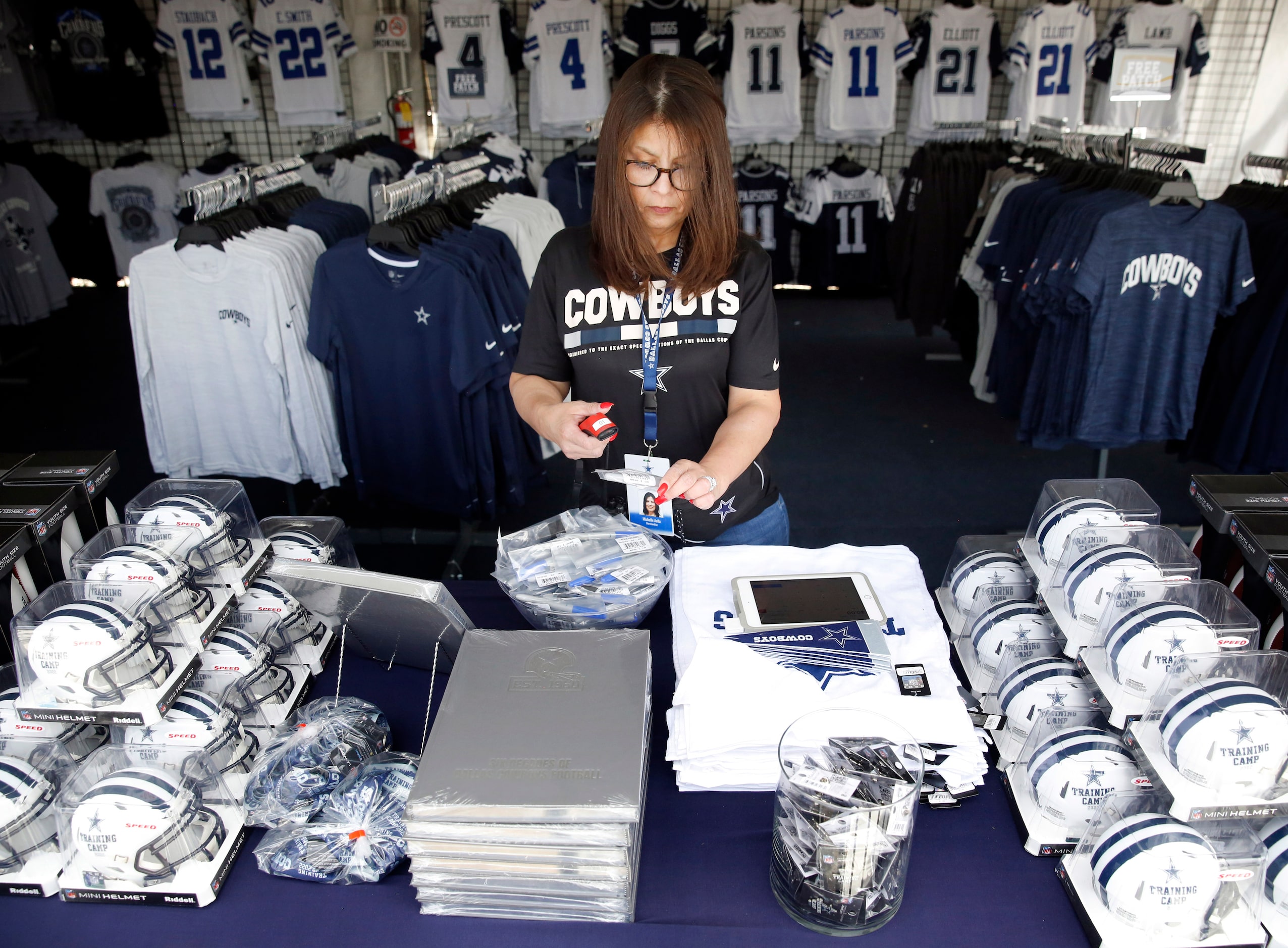 Dallas Cowboys Pro Shop manager Michelle Avila from San Antonio does price checks a day...