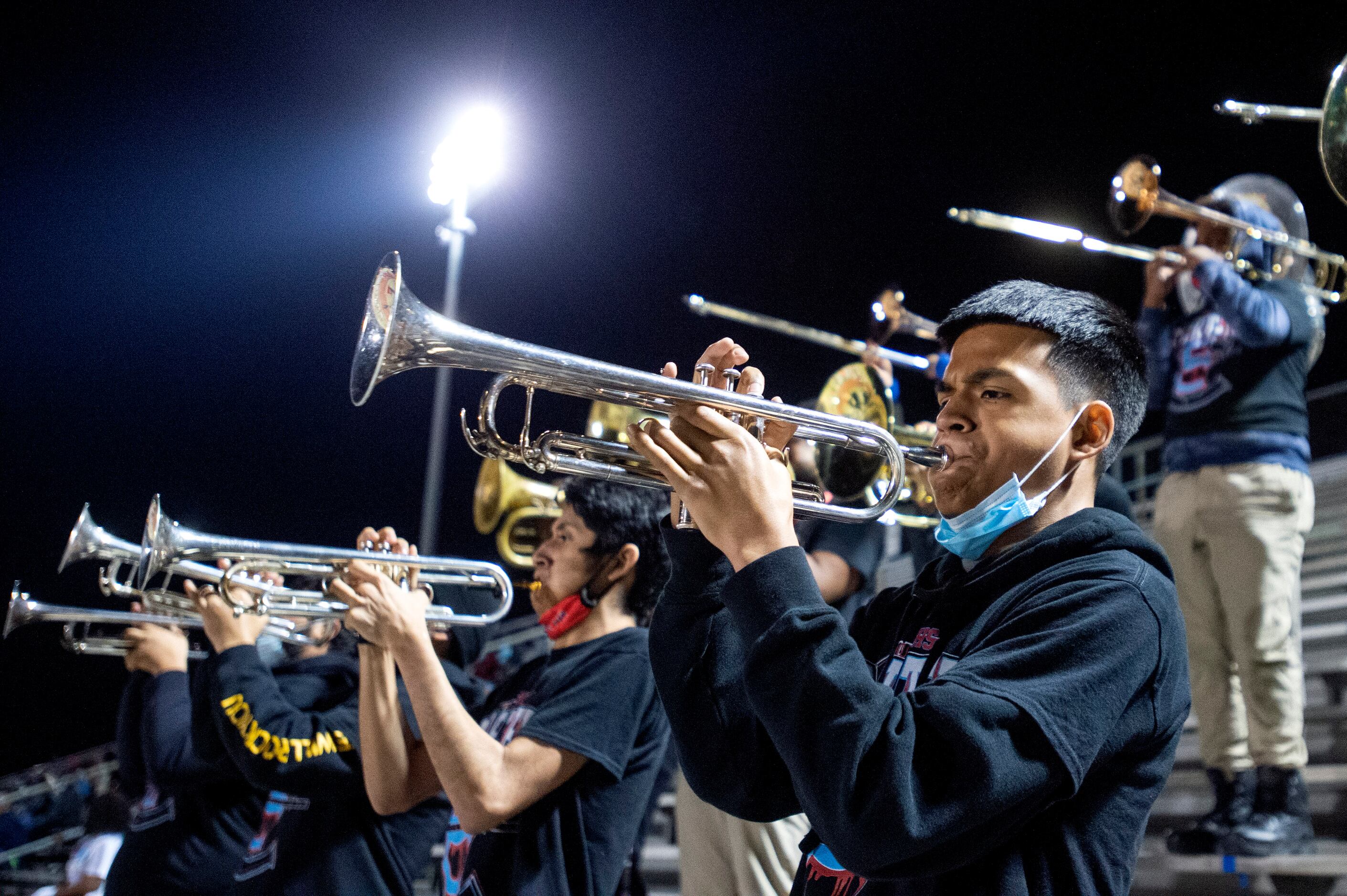 Carter senior Jose Martinez plays the trumpet during the first half of a high school...