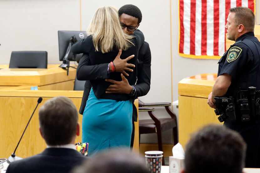 Brandt Jean hugs Amber Guyger during his victim impact statement following her sentencing...
