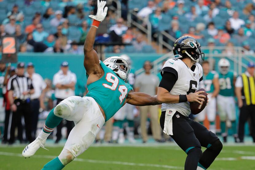Miami Dolphins defensive end Robert Quinn (94) goes after Jacksonville Jaguars quarterback...