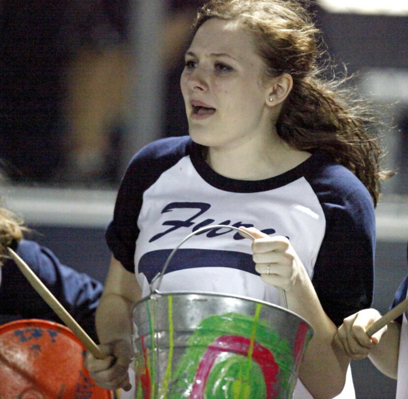 Lauren Oney, 15, of Carrollton, bangs a painted bucket as part of the Prestonwood Christian...