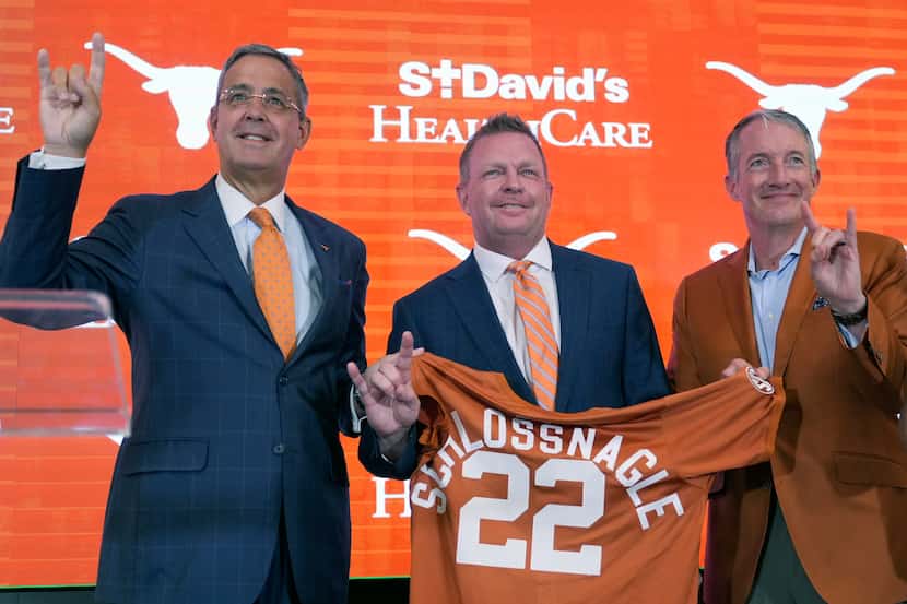 Jim Schlossnagle, center, stands with Texas Athletic Director Chris Del Conte, left, and...