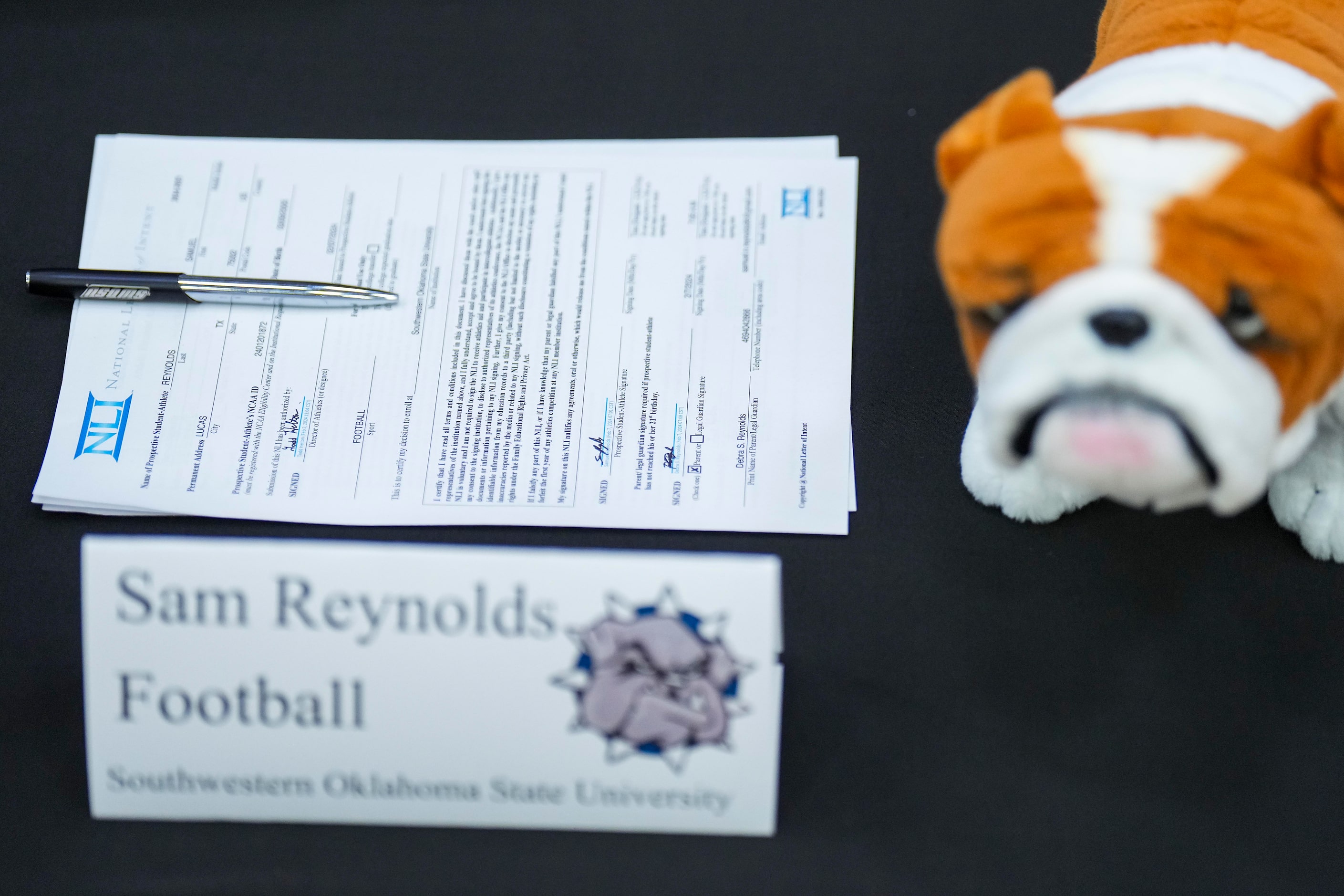 Lovejoy all-state offensive lineman Sam Reynolds’ signing letter rests on a table with the...