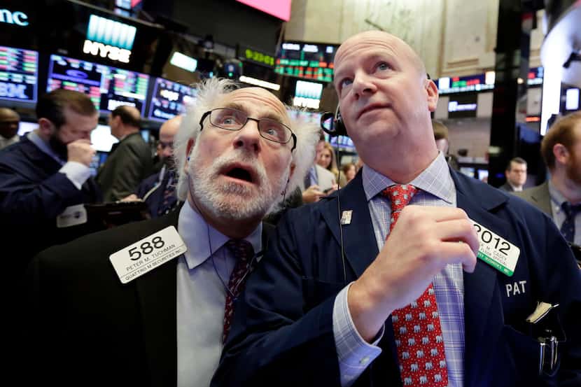 Traders Peter Tuchman, left, and Patrick Casey work on the floor of the New York Stock...